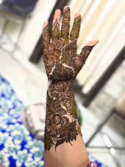 A close-up of the hibiscus design on the back of the hand.