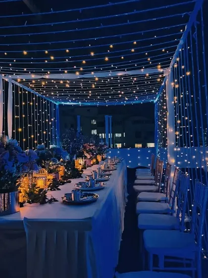 We can transform any space into an elegant setting, like this intimate rooftop dinner. A canopy of fairy lights and deep blue ambient lighting created a magical atmosphere for a special corporate gathering.