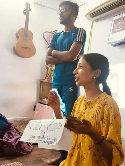 A young woman presents her group's work during a session. We use peer learning and collaborative tasks to build teamwork and presentation skills.