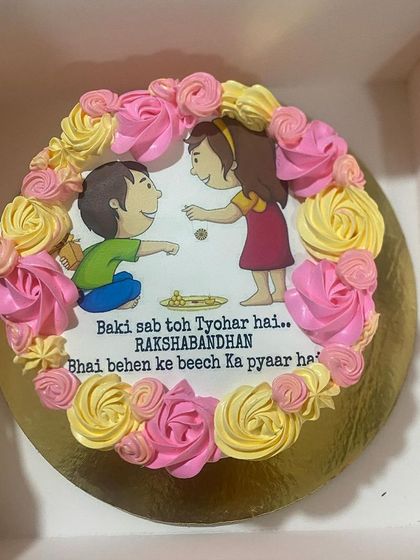 A special cake for Rakshabandhan, this one features an edible print of a brother and sister, surrounded by pink and yellow buttercream roses. It’s a sweet way to celebrate the sibling bond.