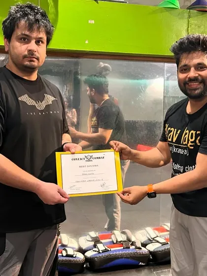 Presenting a certificate to a student who has shown exceptional dedication. This is a recognition of his hard work and progress.