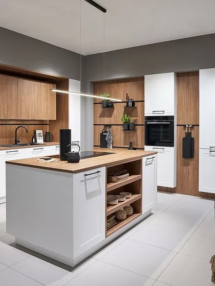 A beautiful combination of white shaker-style cabinets and warm wood paneling. The island provides extra storage and workspace, making it both functional and stylish.