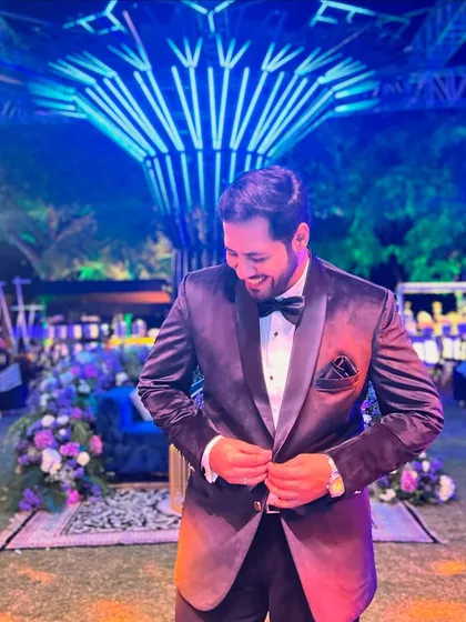 Buttoning up the jacket, getting ready to hit the stage. A small ritual before the big show begins.