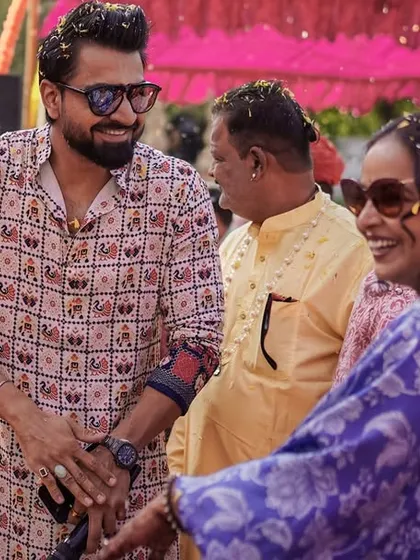 Sharing a laugh with guests during the Haldi festivities. These candid interactions are what make the event feel personal and special.