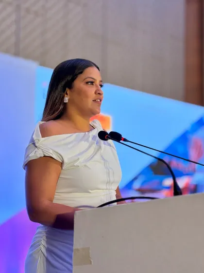 Speaking at the podium, I ensure my delivery is professional and engaging for the senior executives in attendance.