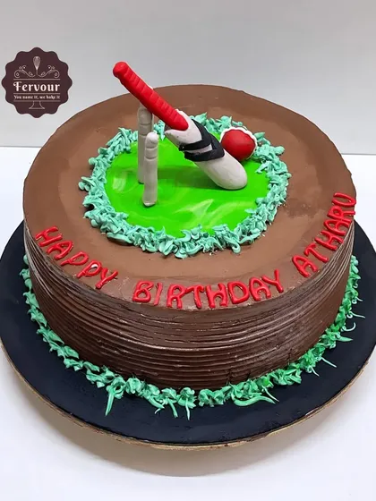 A simple yet effective cricket theme cake. This chocolate truffle cake is frosted with chocolate and decorated with a fondant bat, ball, and wickets on a patch of green.