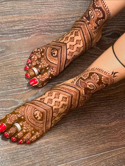 A side view of the detailed elephant and peacock foot design, showing how the patterns wrap around the foot.