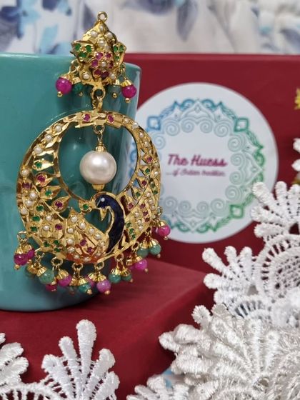 A side view of the blue 'मोर चंदबाली', showing the depth and detail of the enamel work on the peacock motif.