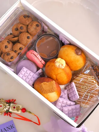 This is our limited edition Grazing Box, a perfect example of how we pack joy and indulgence for your special occasions. It includes a variety of our freshly made, 100% eggless delights like assorted bombolinis, cookie cereal, macarons, and stroopwafels, all ready to be shared.