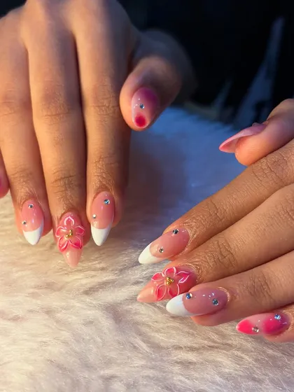 A full view of our pink floral vacation nails. The combination of bright colors and playful 3D art makes this the perfect set for a tropical getaway.