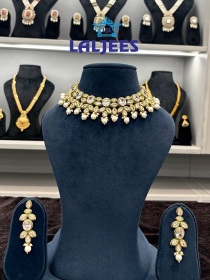 A simple and elegant kundan and pearl choker set. It's perfect for an engagement or sangeet look, and it's lightweight enough to wear comfortably for hours.