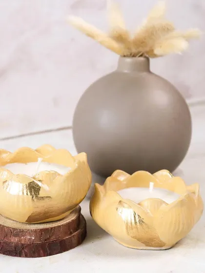 Two of our yellow Lotus Jars, perfect for unwrapping the scent of the festivals. Their cheerful color and warm glow brighten any room.