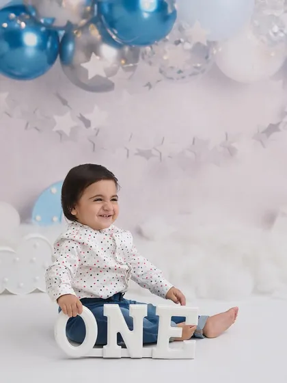 Celebrating the big "ONE" is a huge milestone. We have a variety of setups with custom signs, balloons, and props to make your baby's first birthday portrait session special.