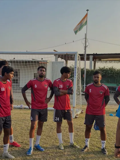 Players listening intently during a break in training. The Indian flag in the background is a constant reminder of the pride we play with.