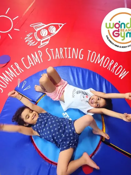 "Summer Camp Starting Tomorrow" - an exciting announcement with kids relaxing after a fun session.