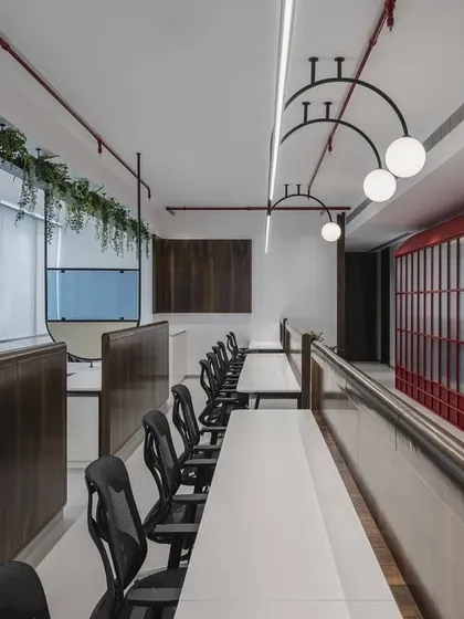 In this office, a conference room echoes the charm of a classic red telephone booth. It's a sanctuary where creativity dials up its brightest colors, turning the mundane into the extraordinary.