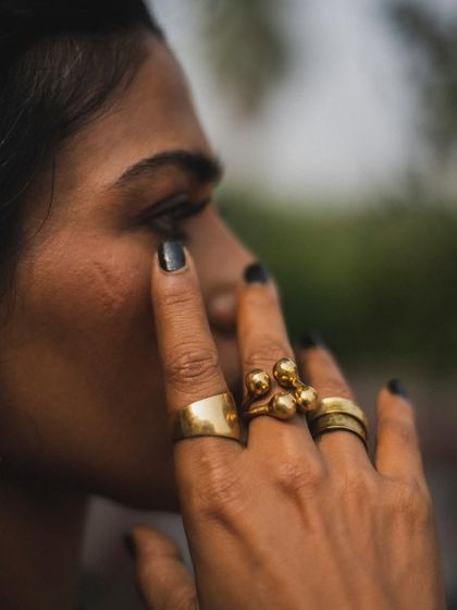 An intense and soulful close-up of actor Anasuya Sengupta. This portrait focuses on her expressive eyes and the beautiful brass rings, capturing a moment of raw emotion and strength.
