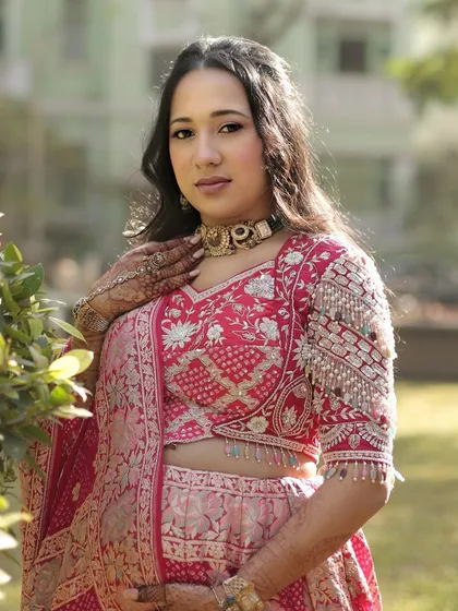 A stunning portrait of mom-to-be Dhwani. Her pink and red lehenga is so vibrant, and we kept the makeup fresh and radiant to match.