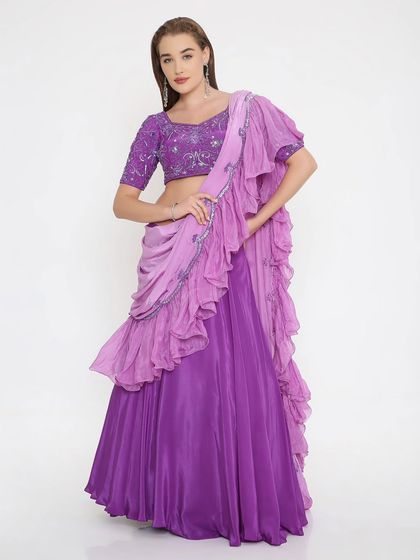 Lavender dreams, stitched for the spotlight. This flowy lehenga with a hand-embroidered blouse and layered ruffle dupatta is for those who love soft elegance with a hint of drama.