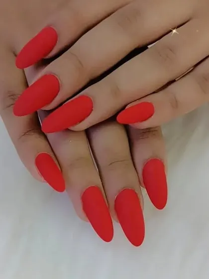 If you love bold and confident nails, this look is for you. This set showcases long, almond-shaped nails with a vibrant, matte red polish for a striking finish.