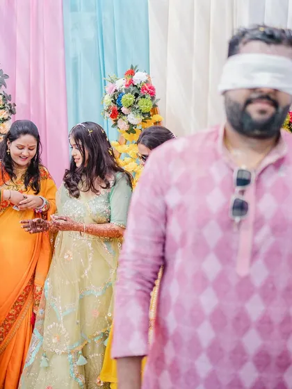 A playful moment from a Haldi ceremony, capturing the fun and games that are often part of this vibrant event.