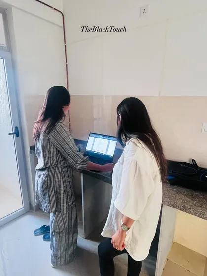 Our team collaborating on-site, reviewing plans on a laptop. This ensures everyone is aligned and the execution matches the design intent perfectly.