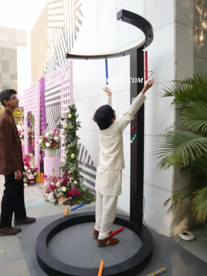 Even the youngest guests enjoy the interactive games we arrange, like this fun reaction time game at the Haldi event.