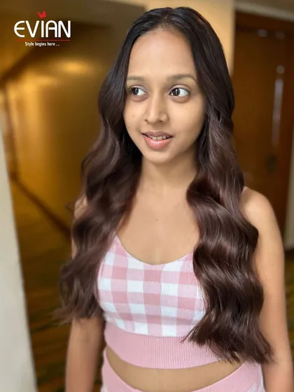 A happy client with her new global hair color, achieved using L'Oréal's INOA line, which is an ammonia-free, oil-based color system.