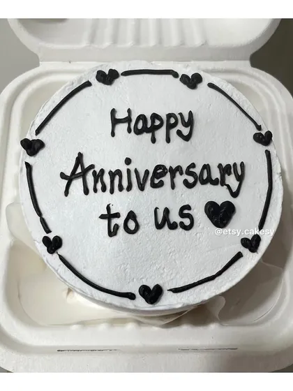 A sweet and simple bento cake to celebrate an anniversary with the message 'Happy Anniversary to us'.