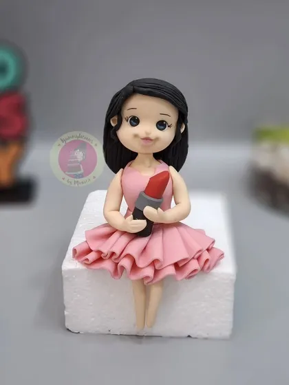 A cute girl figurine with a lipstick, made by a student. Mastering human figurines opens up a whole new world of customization for your clients.
