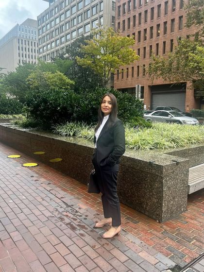 Standing outside on a brick-paved street in Washington D.C. during a work trip. Representing NRI clients means I am constantly learning and adapting. Each case is a new challenge, and it's a part of my job I embrace fully.