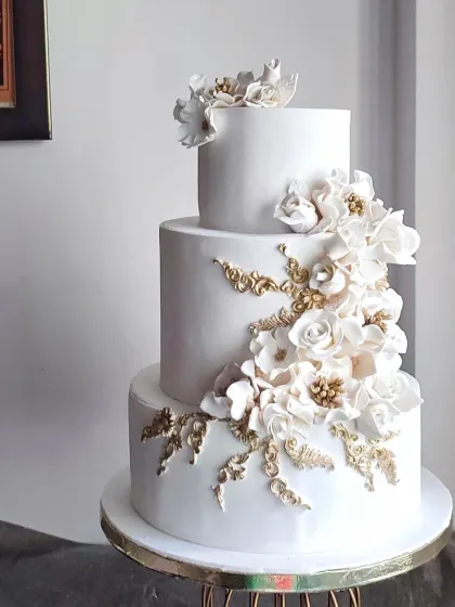 For me, a wedding cake should be pure elegance. This three-tiered beauty features a cascade of handcrafted white and gold sugar flowers, creating a timeless and sophisticated centerpiece. It’s a testament to how classic design can make the most powerful statement on your special day.