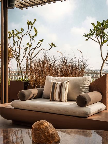 A detail of the custom daybed, positioned to catch the sun. This piece exemplifies our focus on creating comfortable, resort-like spaces for everyday relaxation.