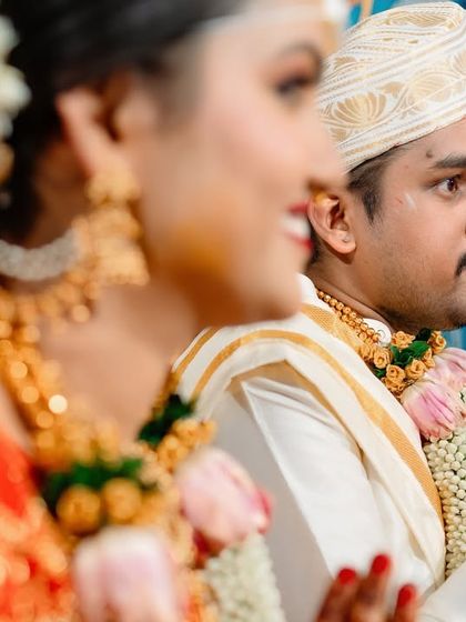 A candid shot of a groom during the wedding ceremony, looking on with a prayerful and happy expression.