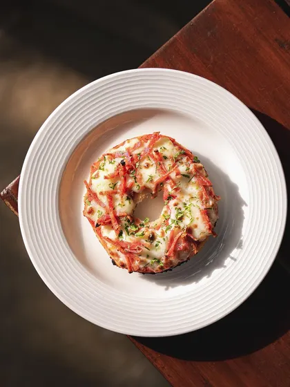 Our Chopped Bacon Pizza Bagel is a savory delight, with crispy bacon bits melted into the cheese on top of our signature bagel.