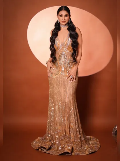 A powerful front-facing pose that showcases the incredible detail and sparkle of the gown. The simple background makes the entire look pop, emphasizing its glamour.