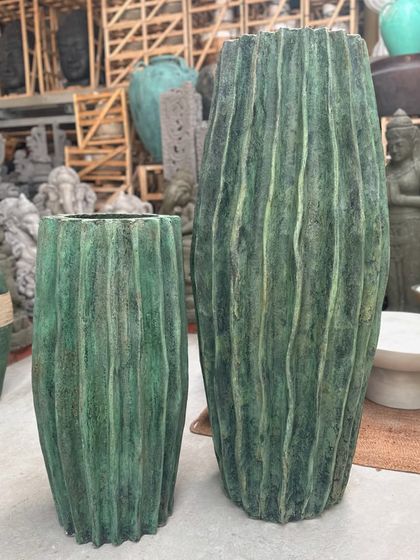 A pair of 'Luis' planters with a ribbed texture and a regal green finish, adding height and elegance.