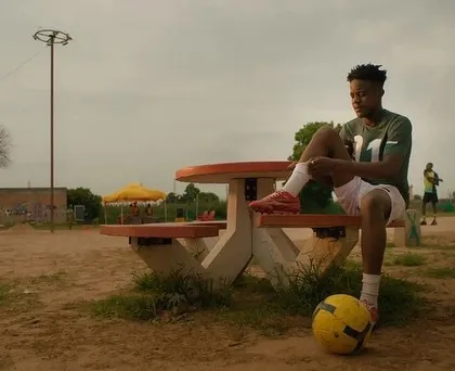 A solo shot of one of the main actors from the SanDisk ad. The athletic styling with the football establishes his character and role within the story.