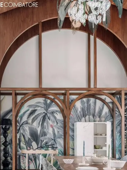 A tropical mural framed by the beautiful wooden arches of a dining room in Coimbatore. The artwork adds a layer of depth and a touch of nature to the grand architectural space.