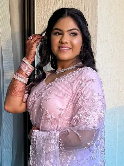 A candid moment of the bride, her hair and makeup looking effortlessly beautiful.
