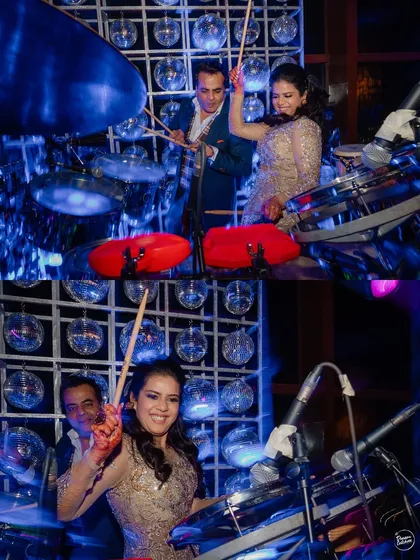 The bride joining in on the fun and trying her hand at the drums. We love capturing these spontaneous, joyful moments during the party.