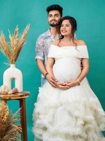 Looking towards their future together. This couple's studio shot is filled with happiness, featuring the beautiful white ruffled gown that gives off an angelic and pure vibe.