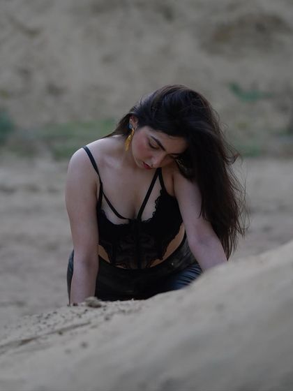 A candid-style shot from the sand shoot, showing a more vulnerable and soft moment.