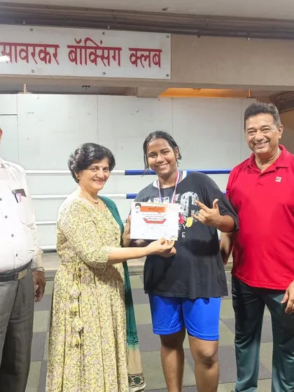 Presenting the certificate and medal to one of our gold medal winners at the division level boxing tournament.
