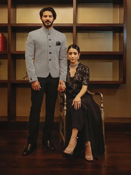 The full couple's look, showing how the classic black and white outfits by Shahab Durazi create a timeless and elegant statement.