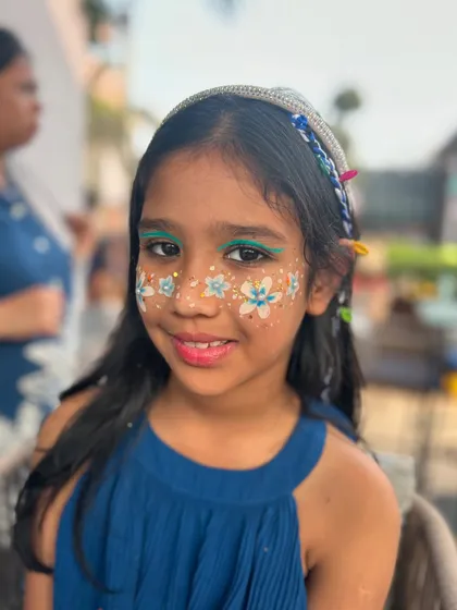 This little girl wanted flowers all over her face, and I was happy to oblige! The little white and blue daisies with glitter are so cheerful.