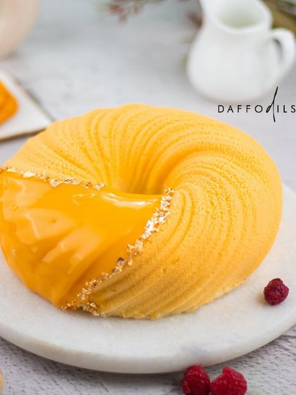 The Mango Raspberry entremet is a true work of art. This photo highlights its beautiful swirled texture, with a partial shiny glaze and delicate gold leaf. It is as delicious as it is stunning.
