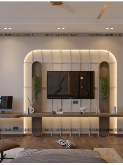This bedroom features a beautifully crafted TV unit with a curved, upholstered backdrop. An extended floating desk provides a spacious and elegant workspace, seamlessly integrated into the room's design.