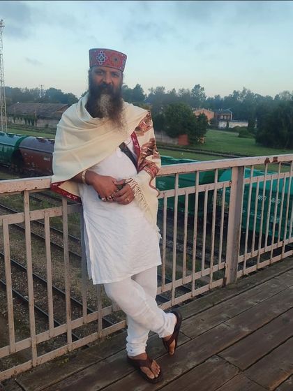 Leaning against a railing on a bridge over train tracks. Life is a journey, and like a train, it is always moving forward. The key is to enjoy the ride.