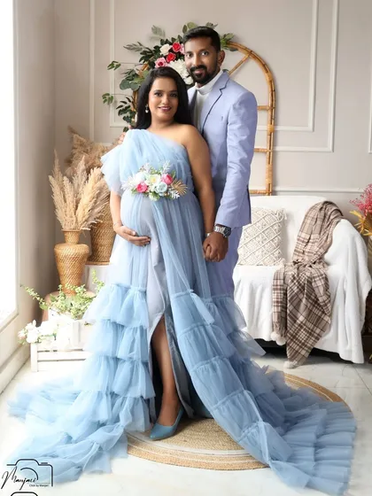 A beautiful full-length portrait of the couple. The flowing blue gown looks magnificent in the bright and airy boho studio.